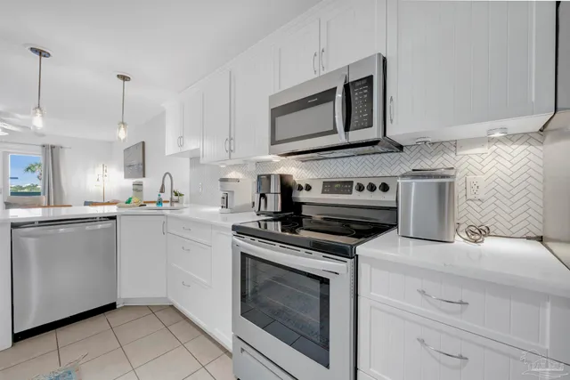 a kitchen with cabinets stainless steel appliances and a counter space