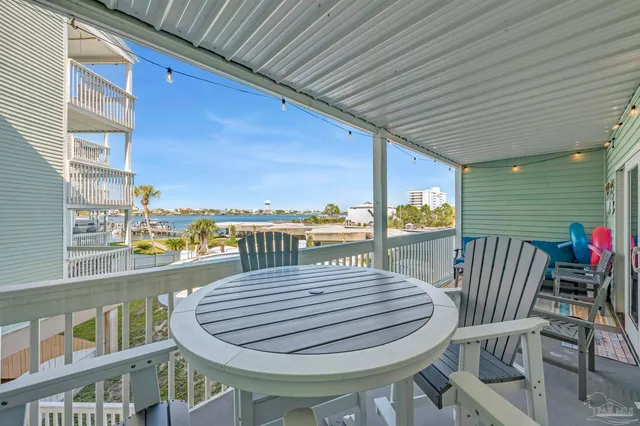 a view of a balcony dining area with furniture