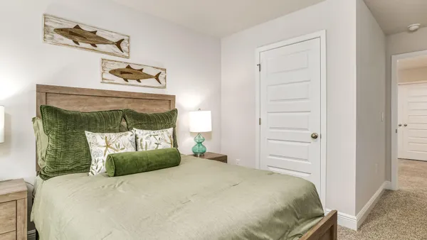 a bedroom with a bed and a mirror