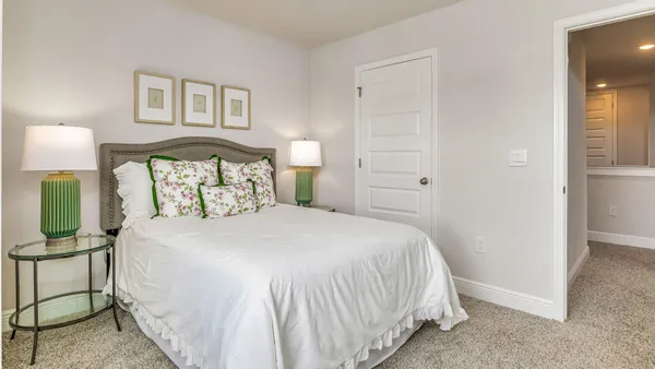 a bedroom with a bed and a night stand
