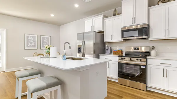 a kitchen with stainless steel appliances granite countertop a sink stove and microwave