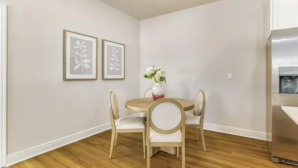 a dining room with wooden floor and dining table