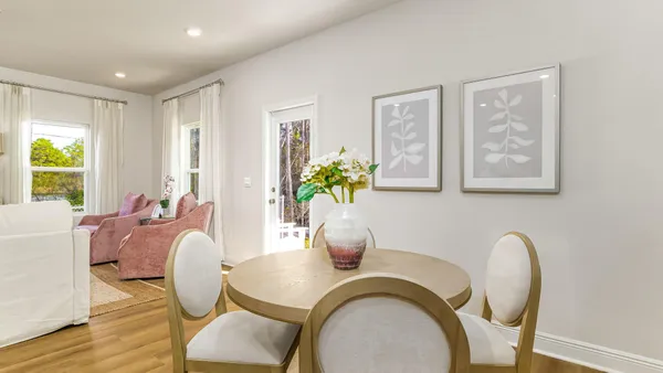 a dining room with furniture and wooden floor