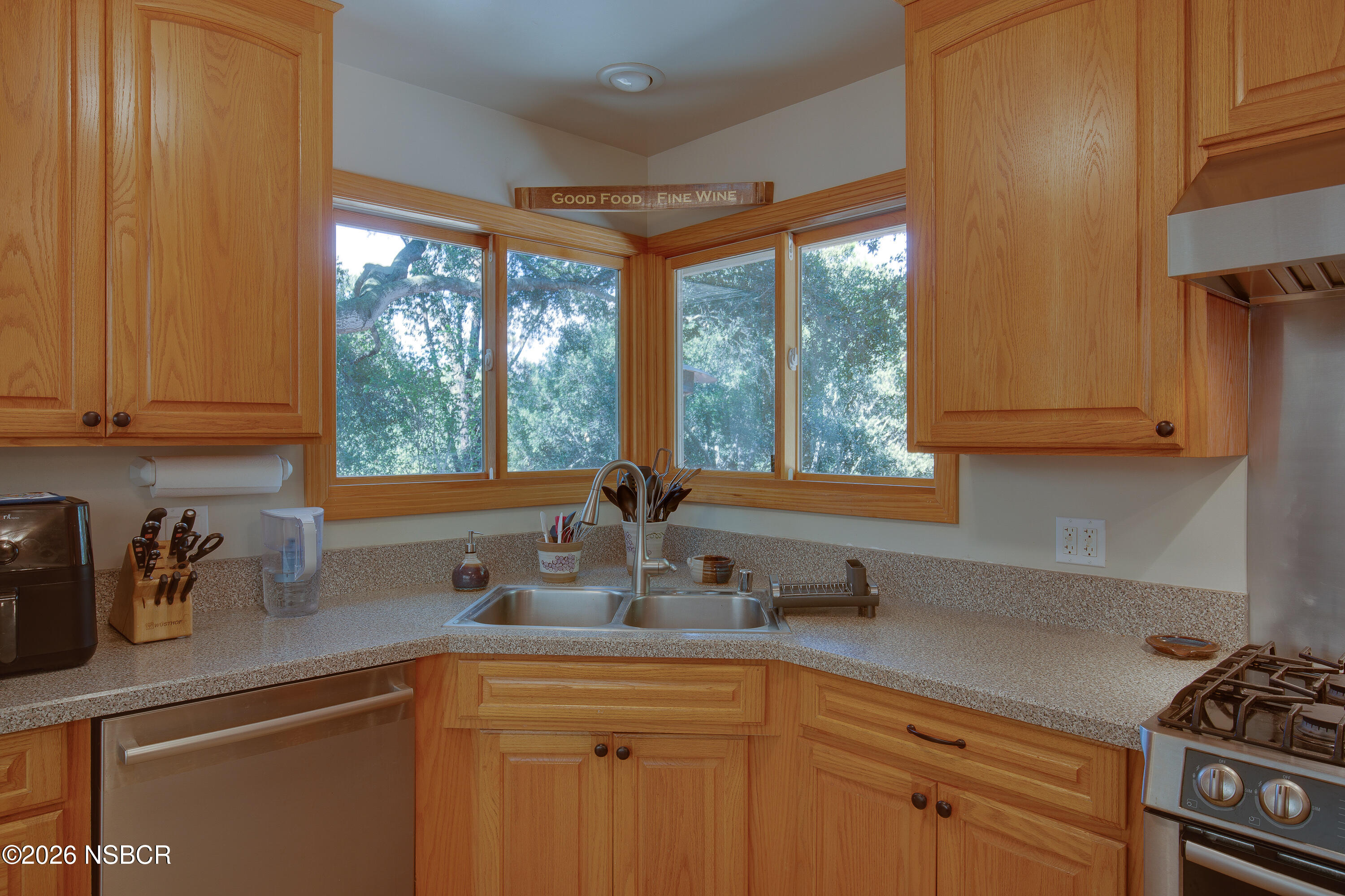 850 Fredensborg Canyon Road Solvang, CA 93463 - Photo 7 of 26 a kitchen with stainless steel appliances a sink a stove and next to a window