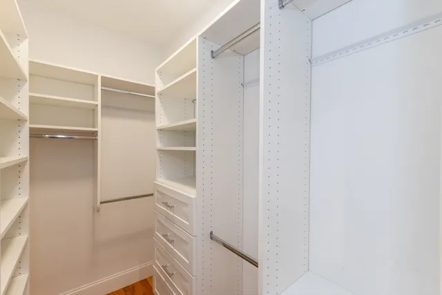 a bathroom with a toilet a sink a mirror and shower