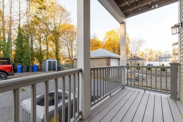 a tall yellow building with trees in front of it