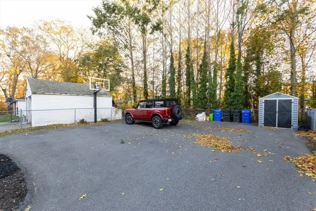 a view of a house with a potted plant and floor to ceiling window and potted plants