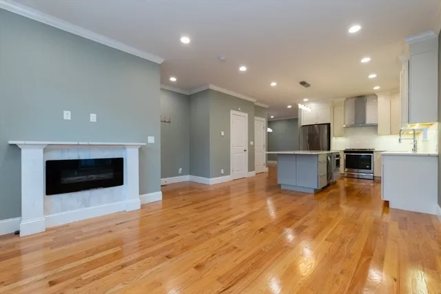 a view of kitchen with kitchen island granite countertop stainless steel appliances and stove