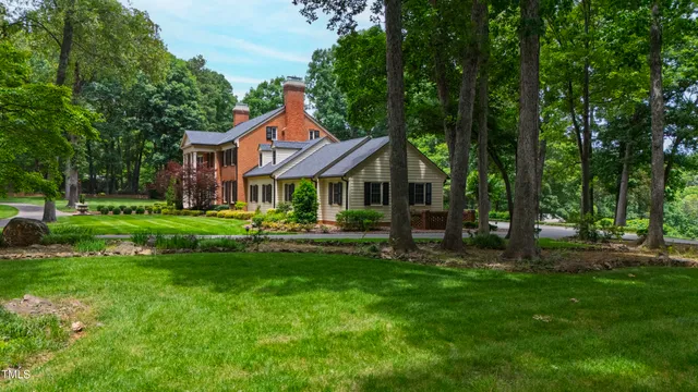 a front view of a house with yard and green space