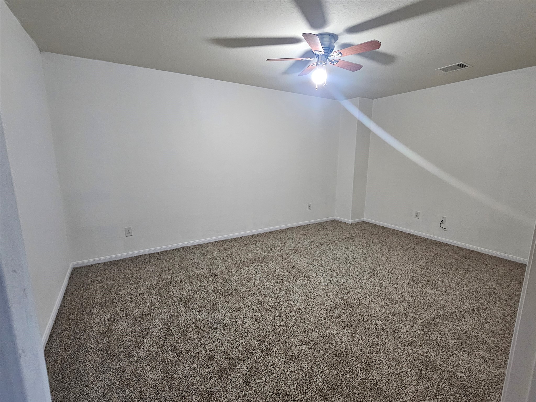 9938 Swallow Drive Conroe, TX 77385 - Photo 9 of 12 an empty room with a fan & a ceiling fan
