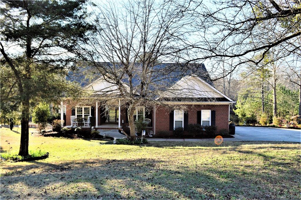 5422 Rehobeth Road, Unit 2 Waxhaw, NC 28173 - Photo 22 of 23 a front view of a house with a yard covered with trees