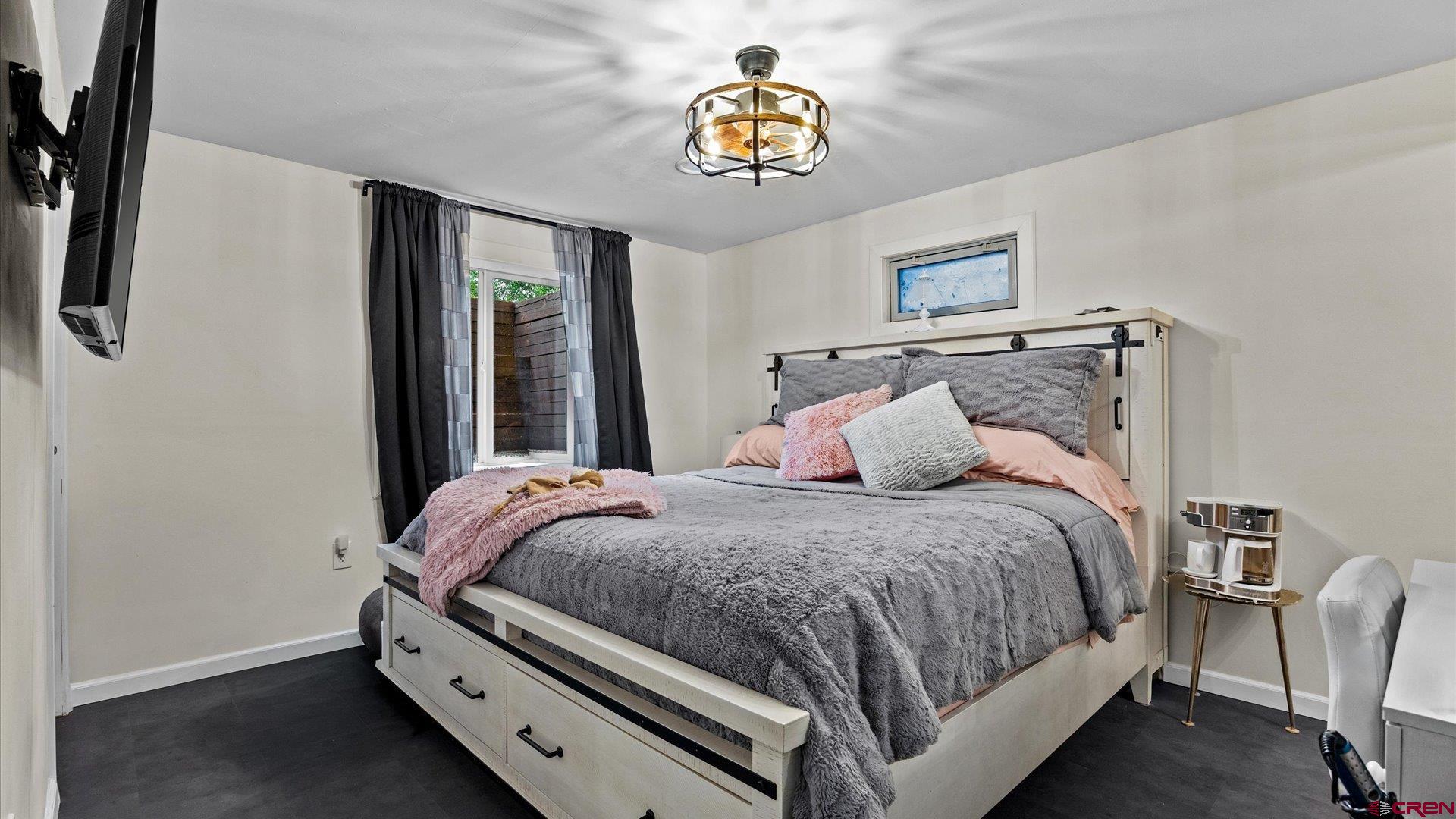 1761 G Road Delta, CO 81416 - Photo 12 of 43 a bedroom with a bed and a chandelier