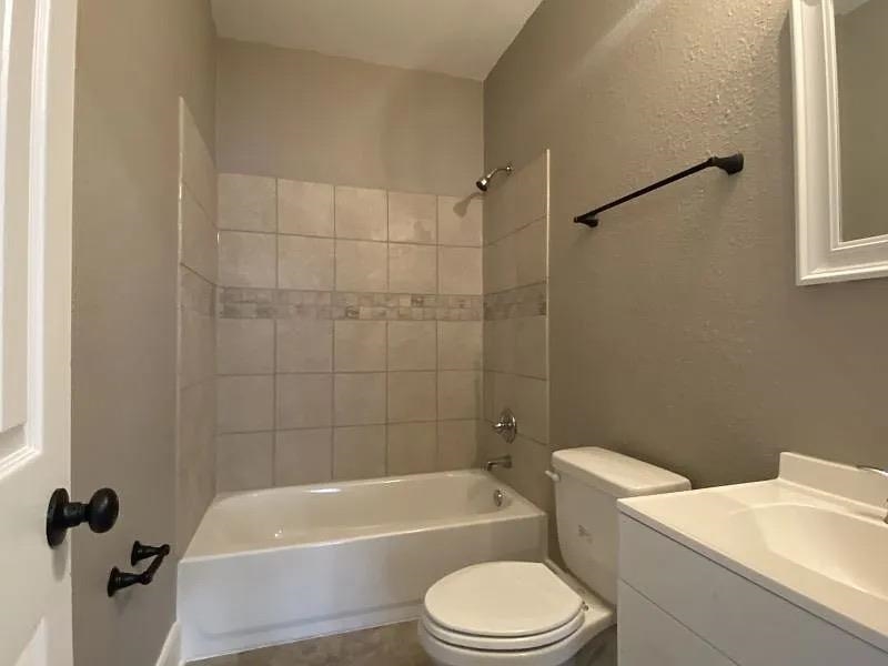 1487 Swift Street Memphis, TN 38109 - Photo 4 of 8 a white toilet and tub sitting next to a bathroom sink