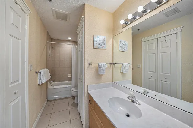 a bathroom with a sink double vanity granite tub and shower