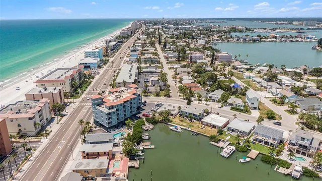 an aerial view of a city with lots of residential buildings and ocean view