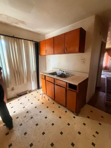 a bedroom with a bed and a dresser in it