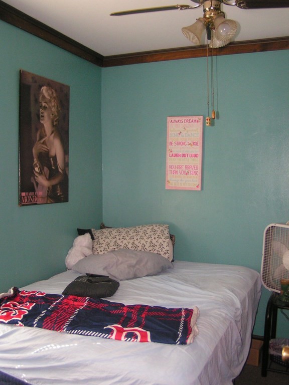 262 Anthony Street Fall River, MA 02721 - Photo 11 of 21 a bedroom with a bed and a chandelier