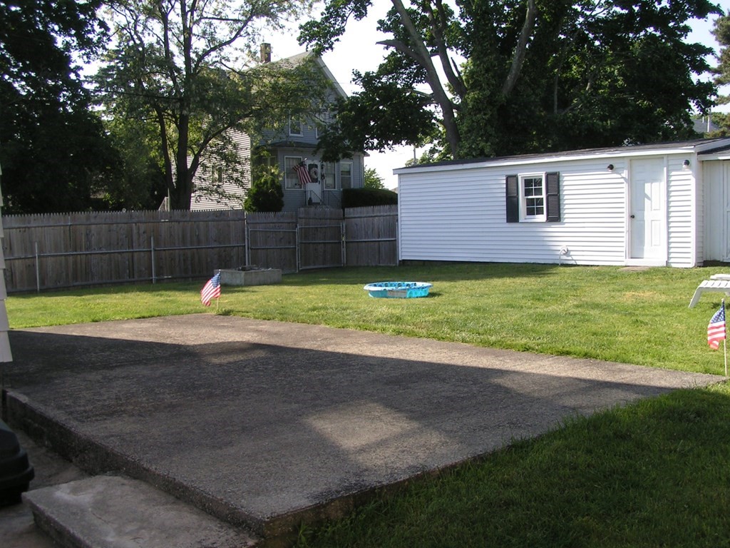 262 Anthony Street Fall River, MA 02721 - Photo 19 of 21 a swimming pool with lots of green space and trees in the background