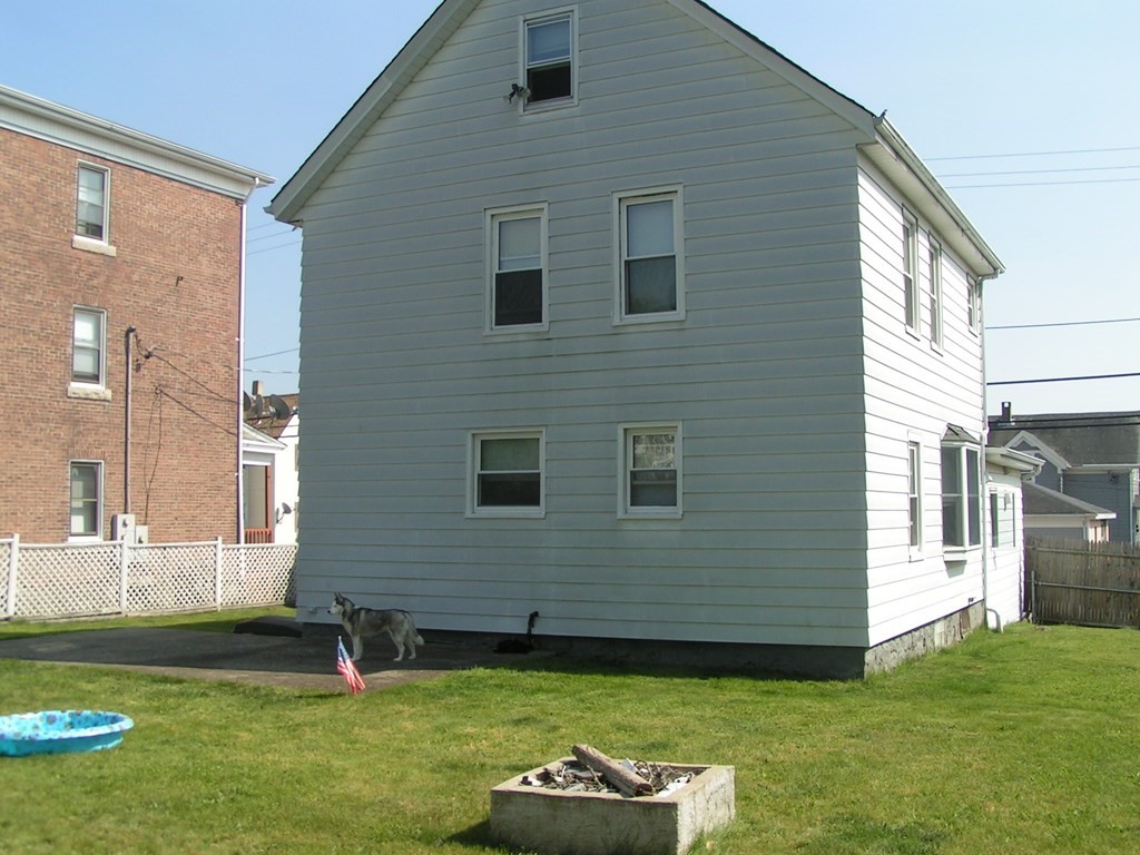 262 Anthony Street Fall River, MA 02721 - Photo 4 of 21 a view of a backyard with plants and large tree