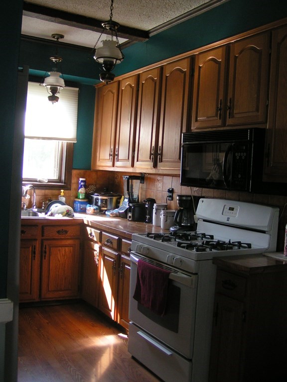 262 Anthony Street Fall River, MA 02721 - Photo 9 of 21 a kitchen with granite countertop a sink stainless steel appliances and cabinets