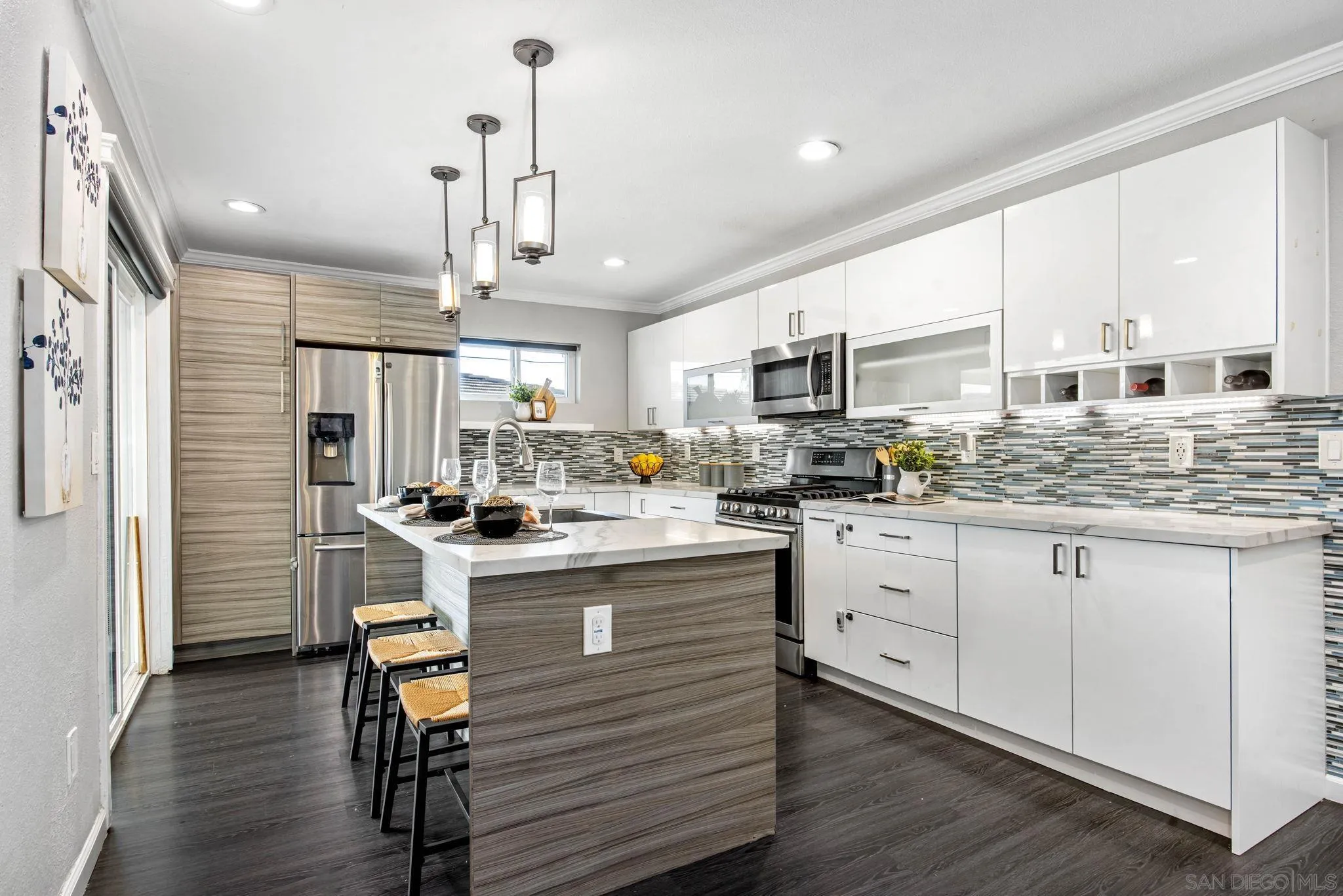 a kitchen with kitchen island granite countertop a sink cabinets and stainless steel appliances