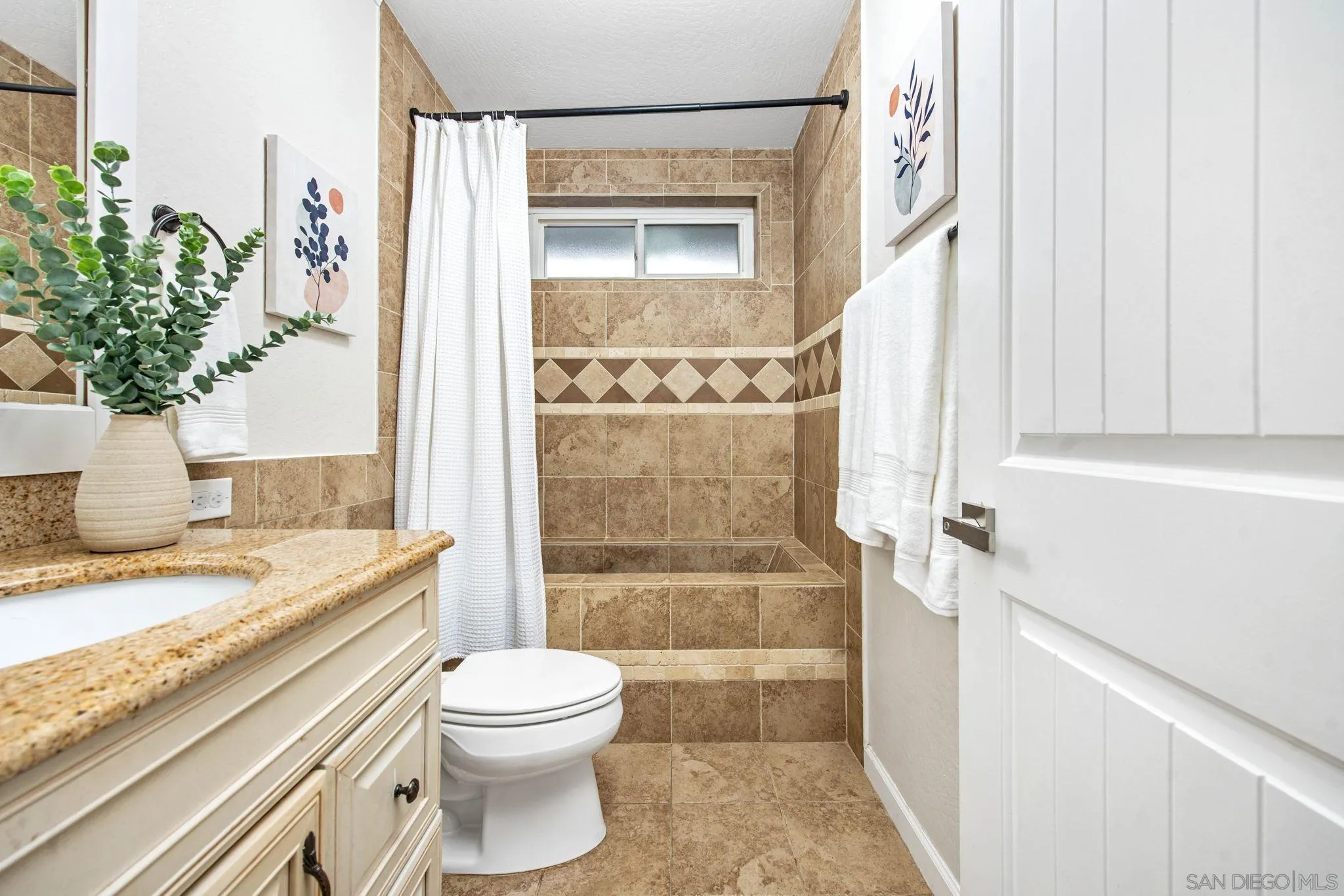 1311 Ramona Avenue Spring Valley, CA 91977 - Photo 13 of 33 a bathroom with a granite countertop sink a toilet and shower
