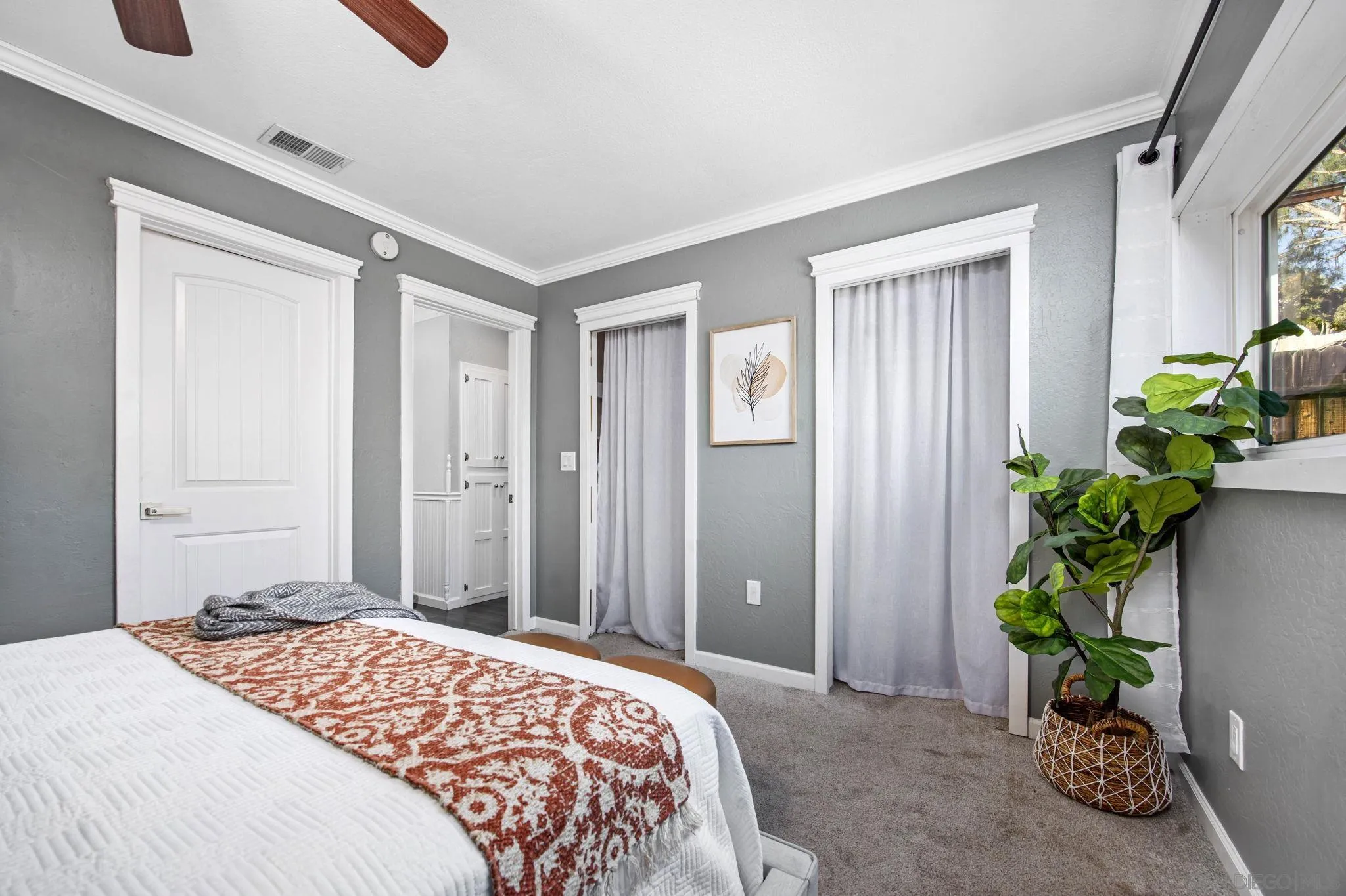 1311 Ramona Avenue Spring Valley, CA 91977 - Photo 14 of 33 a bedroom with a bed potted plant and a window