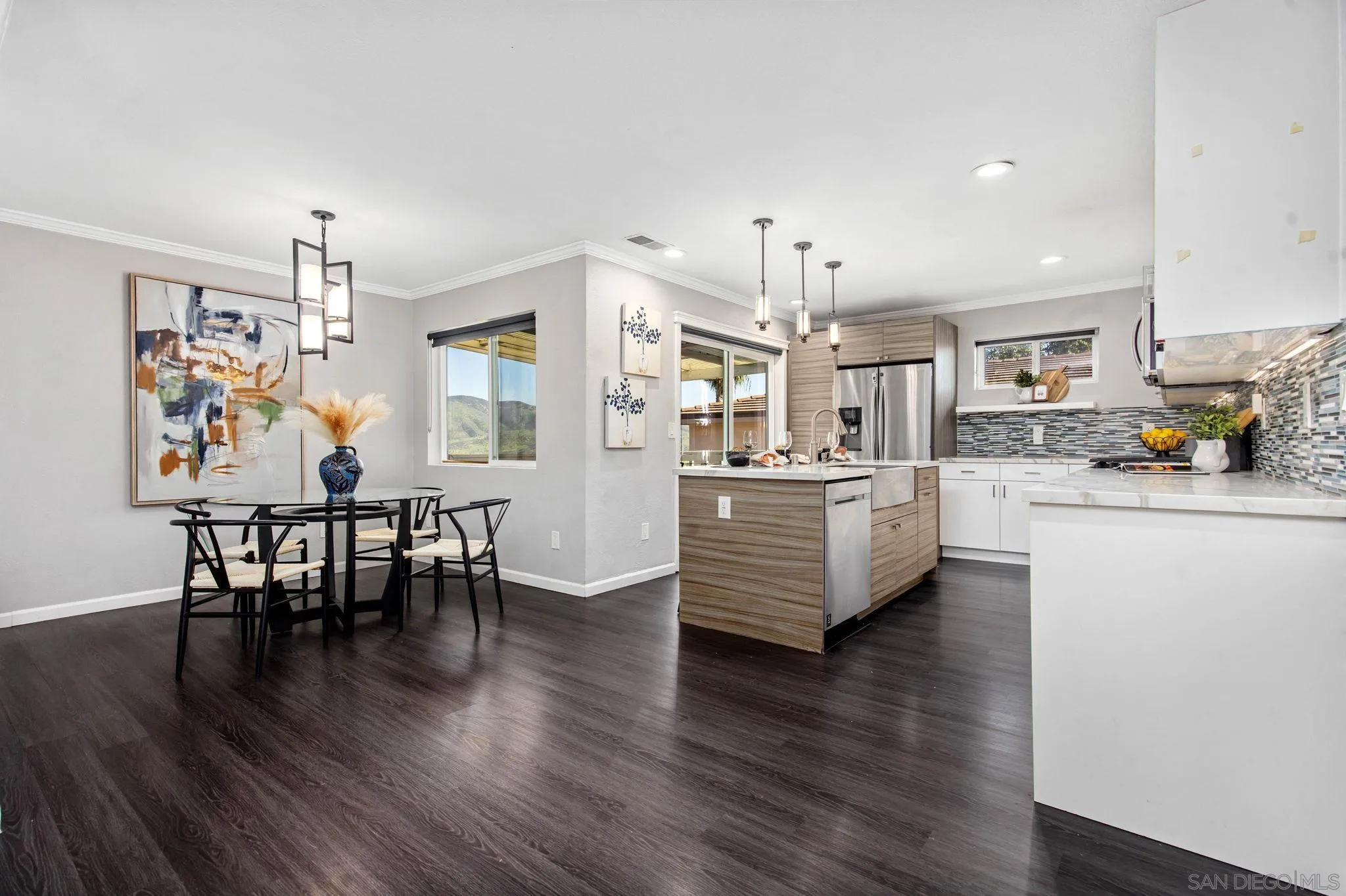 1311 Ramona Avenue Spring Valley, CA 91977 - Photo 3 of 33 a living room with kitchen island furniture and a wooden floor
