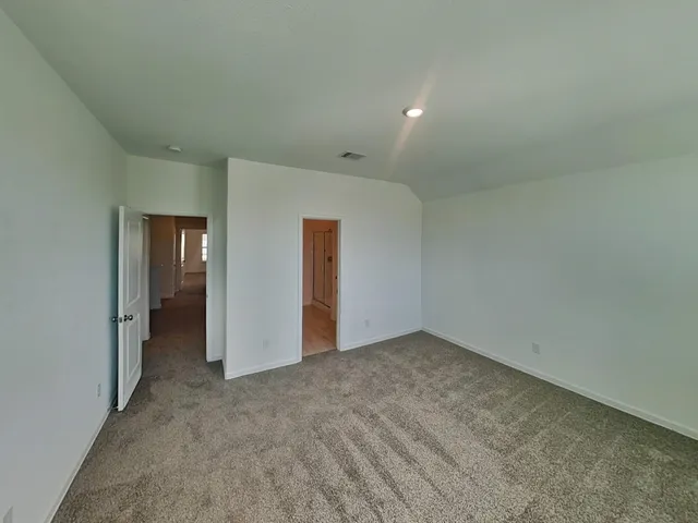 a spacious bathroom with a double vanity sink a mirror and a shower