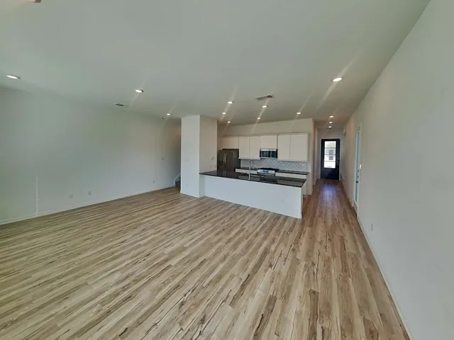 a view of kitchen with granite countertop cabinets and outdoor view