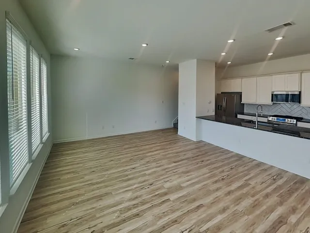 a view of kitchen with refrigerator and window