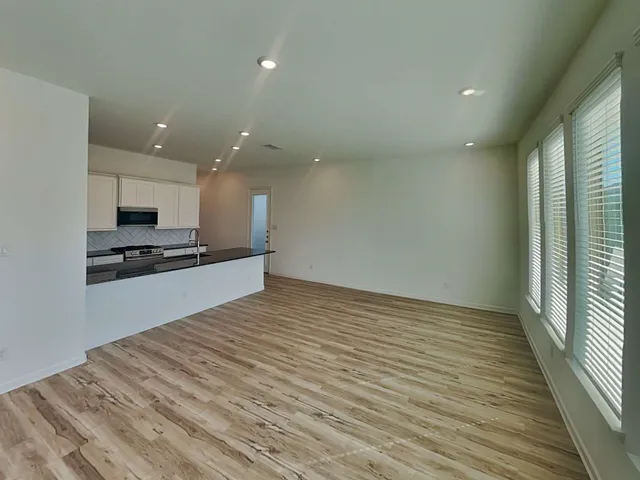 a kitchen with sink a refrigerator and window