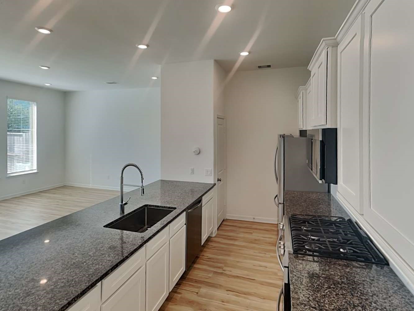 4026 Champlain Way Iowa Colony, TX 77583 - Photo 8 of 17 a kitchen with sink a refrigerator and window