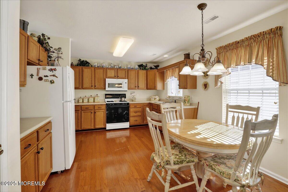 54 Merion Lane Jackson, NJ 08527 - Photo 11 of 46 a kitchen with a table chairs stainless steel appliances and cabinets