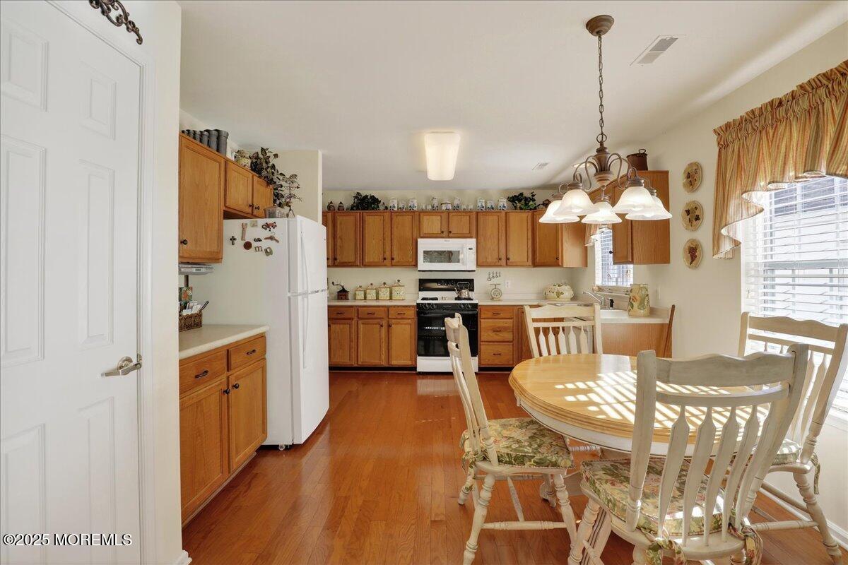 54 Merion Lane Jackson, NJ 08527 - Photo 14 of 46 a kitchen with stainless steel appliances kitchen island granite countertop a refrigerator a stove a sink dishwasher with a dining table and chairs