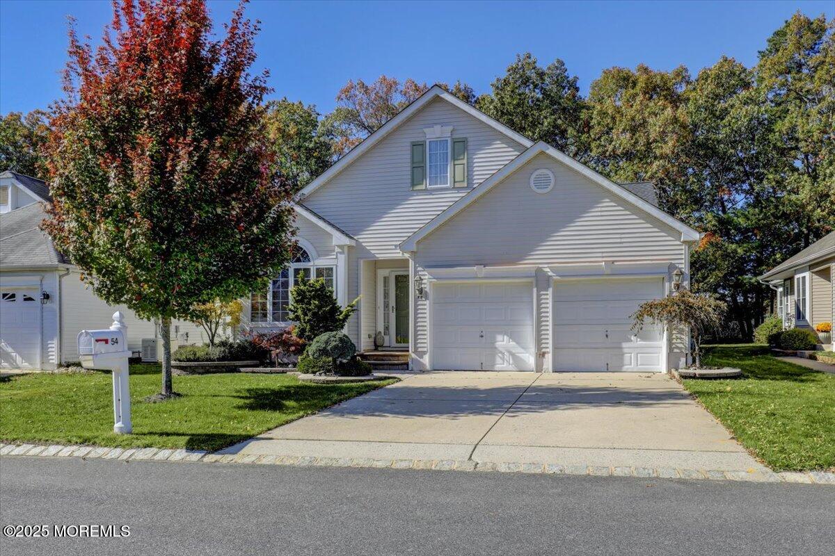 54 Merion Lane Jackson, NJ 08527 - Photo 2 of 46 a front view of a house with a yard and garage
