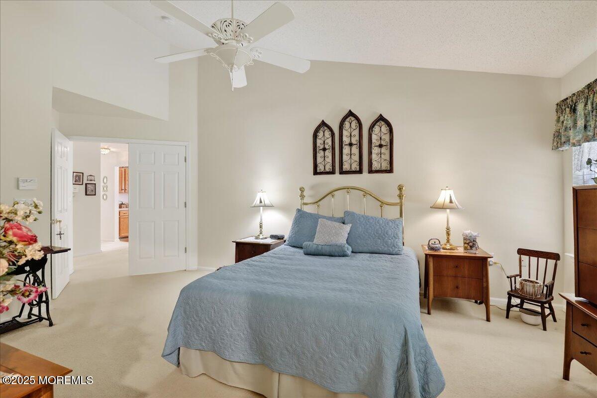 54 Merion Lane Jackson, NJ 08527 - Photo 23 of 46 a bedroom with a bed and a chandelier