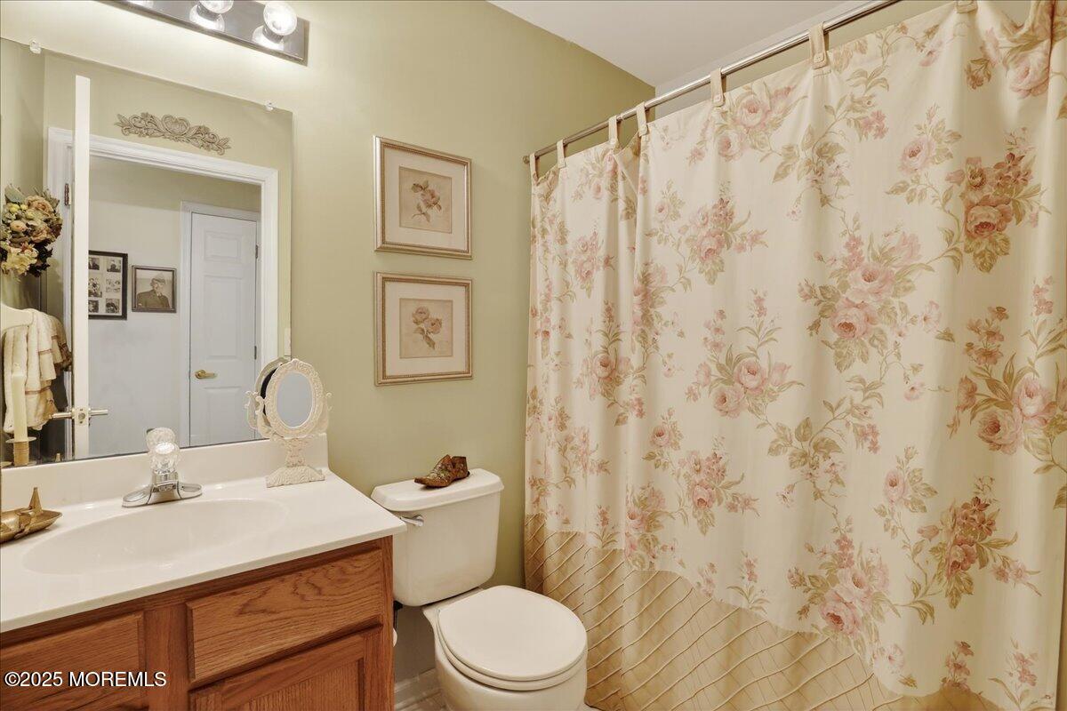 54 Merion Lane Jackson, NJ 08527 - Photo 28 of 46 a bathroom with a sink a toilet and shower curtain