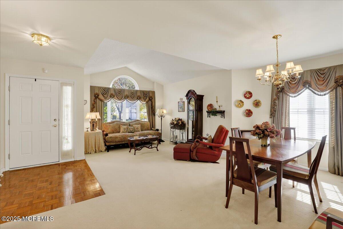 54 Merion Lane Jackson, NJ 08527 - Photo 10 of 46 a living room with furniture and a chandelier