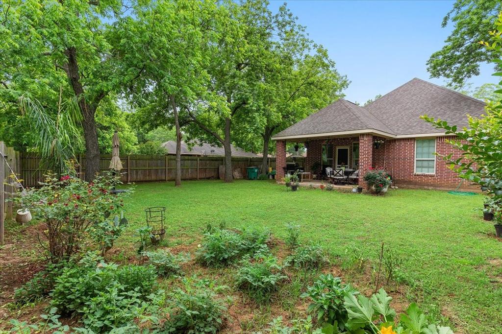 502 Ritchey Street Gainesville, TX 76240 - Photo 27 of 29 a view of a house with a backyard patio and swimming pool
