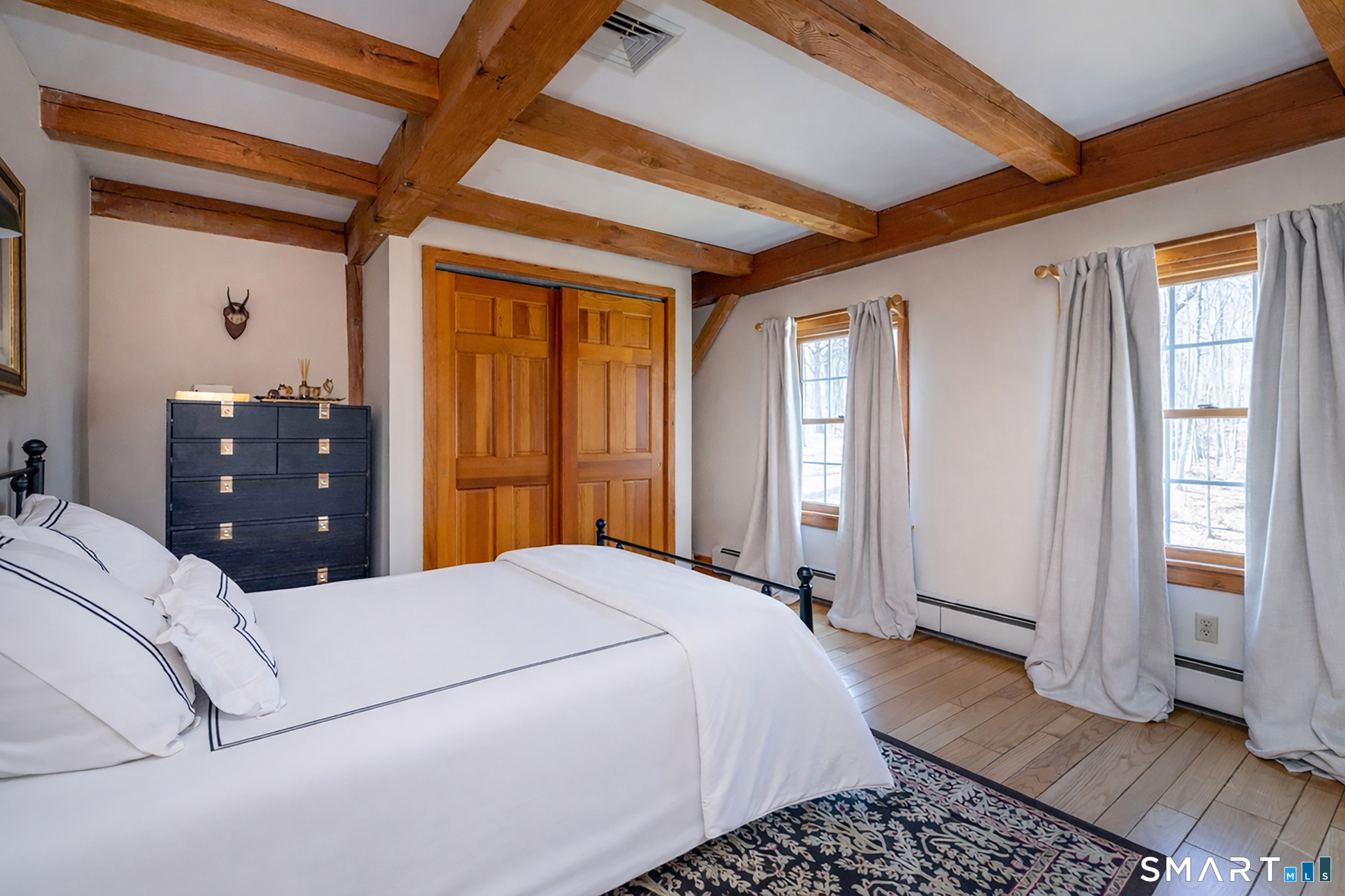 24 Hickory Lane Roxbury, CT 06783 - Photo 21 of 42 a bedroom with a bed and wooden floor