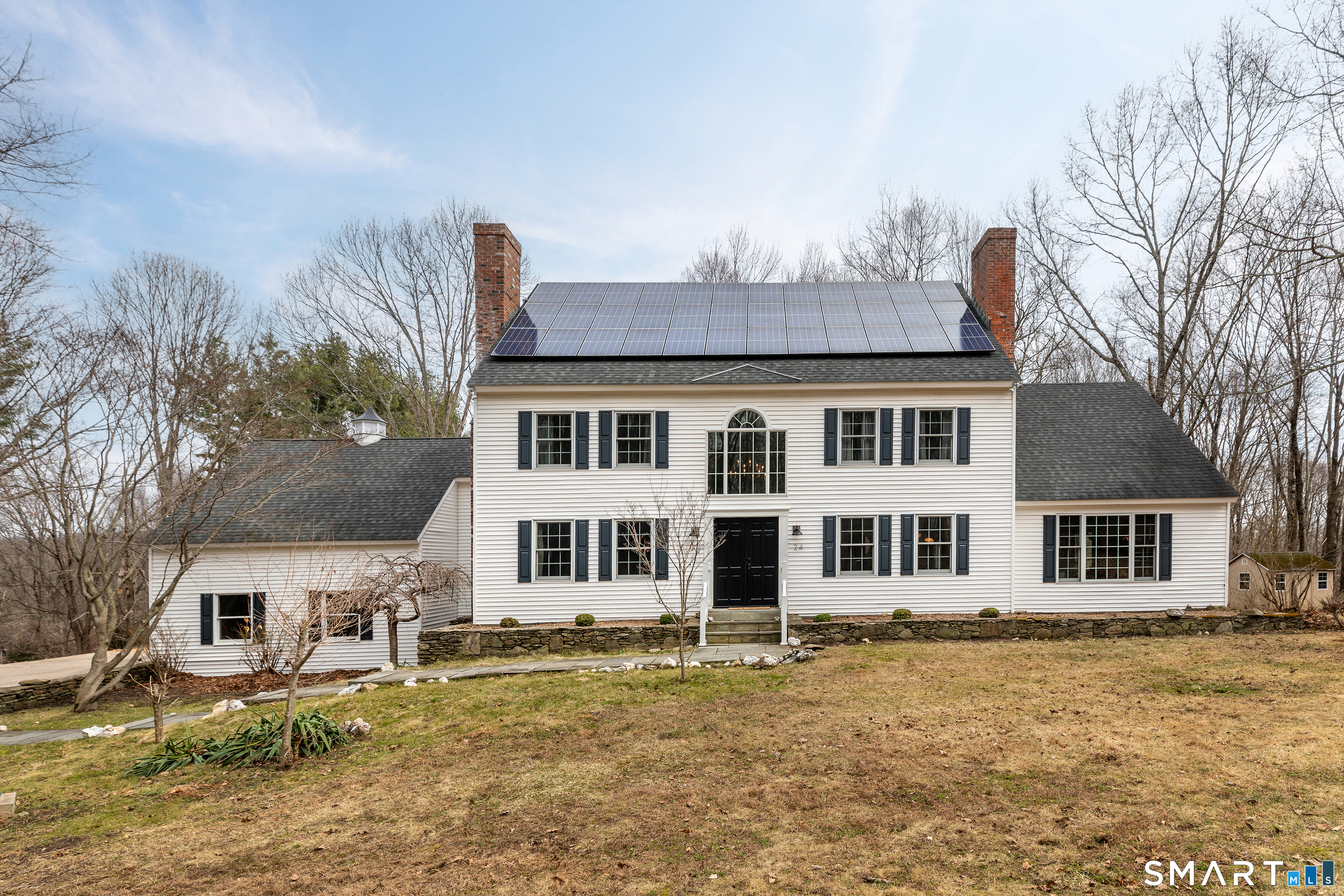 24 Hickory Lane Roxbury, CT 06783 - Photo 6 of 42 a front view of a house with a yard