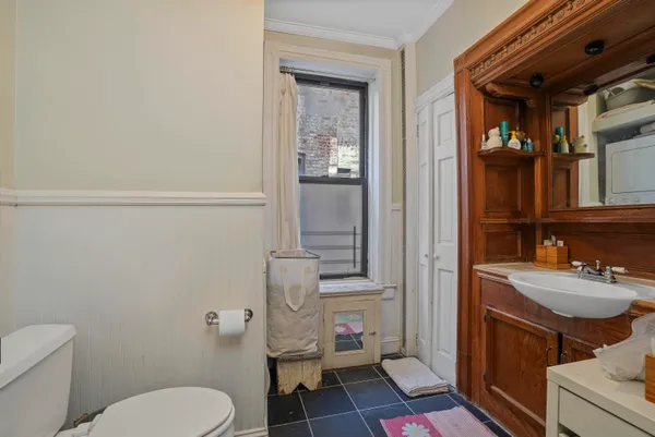 a bathroom with a toilet a sink and shower