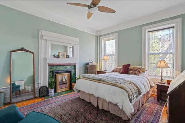 a bedroom with a bed and a fireplace