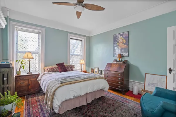 a bedroom with a bed couch and a window