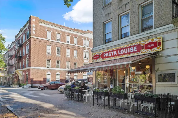 a view of a cafe with a table and chairs in front of it