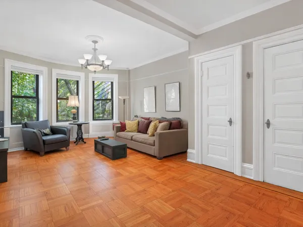 a living room with furniture and a chandelier