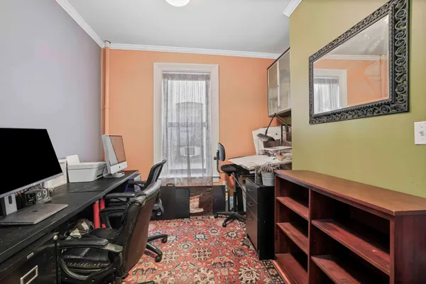 a view of a workspace with furniture and a window