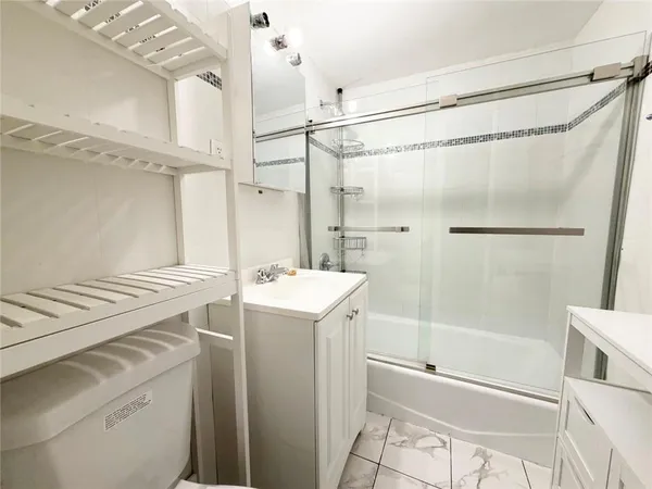 a bathroom with a sink a mirror and a shower