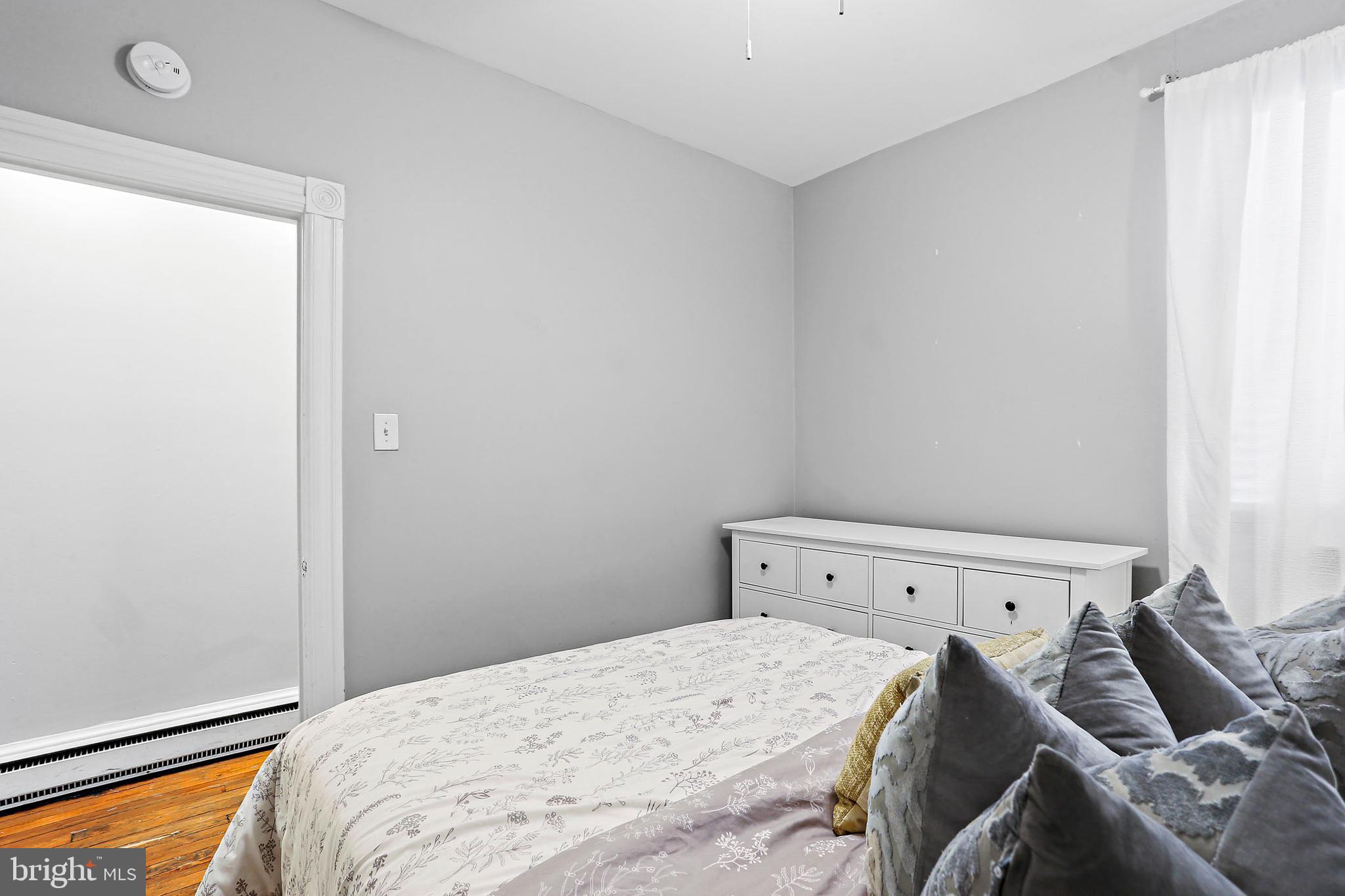 1211 33rd Street Northwest, Unit 1 Washington, DC 20007 - Photo 11 of 18 a bed room with a bed and a window